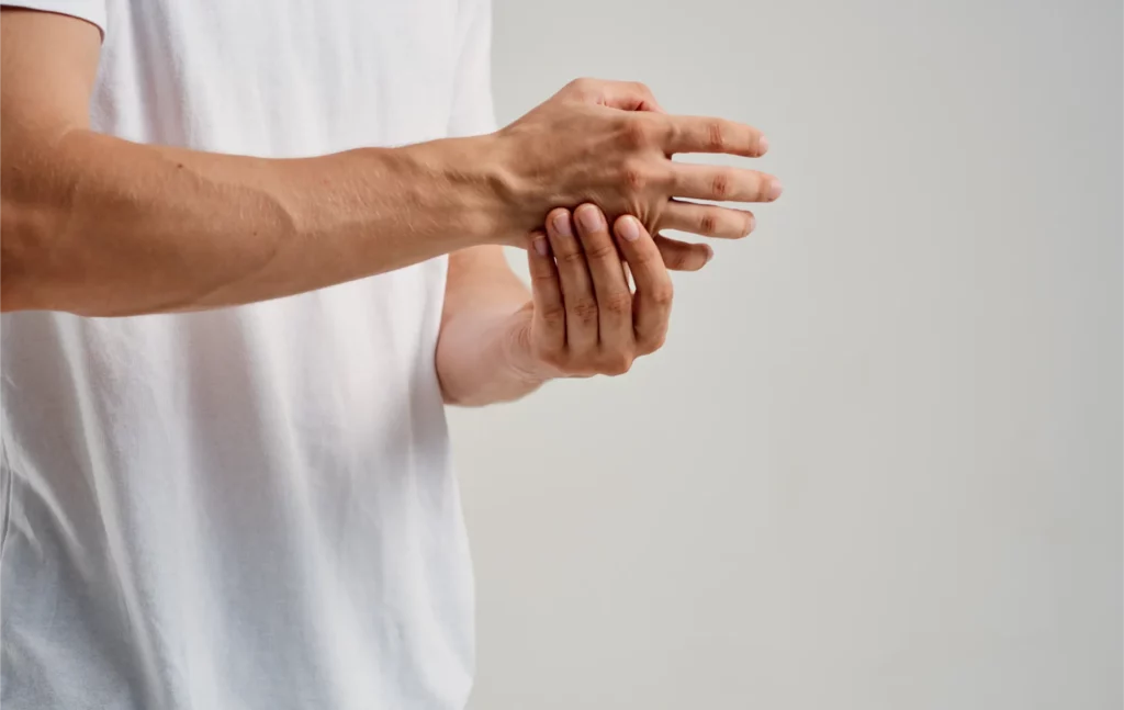 a man touches his wrists on a light background and 2023 11 27 05 17 30 utc