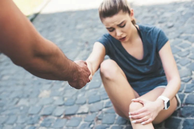 cropped shot of man giving hand to injured sportsw 2023 11 27 05 01 21 utc